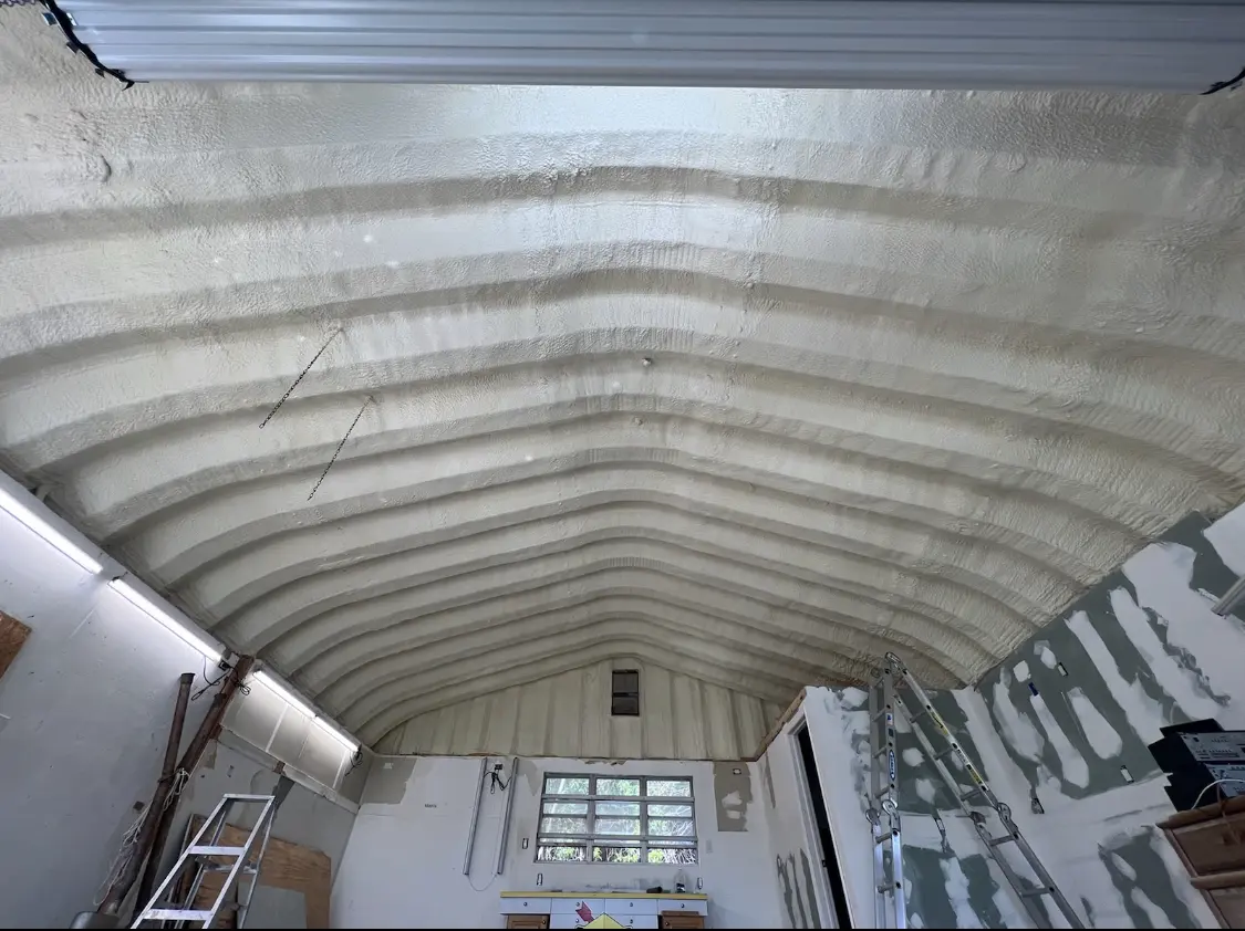 Spray polyurethane foam applied to the underside of a metal roof deck in Larkin
